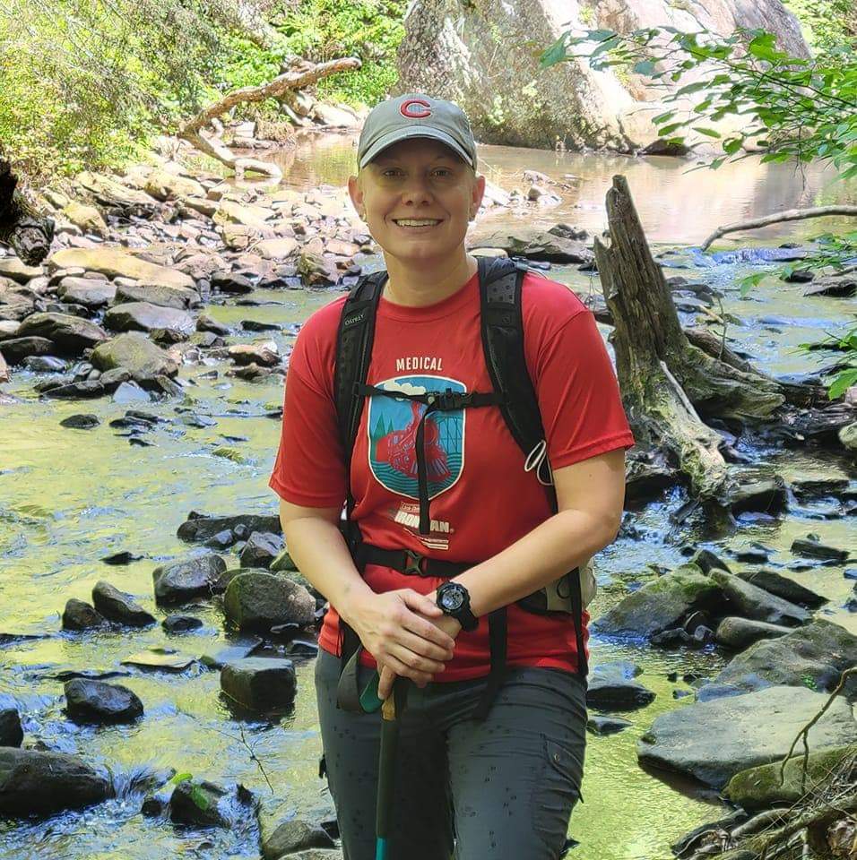 Lynette Carlson hiking along a river